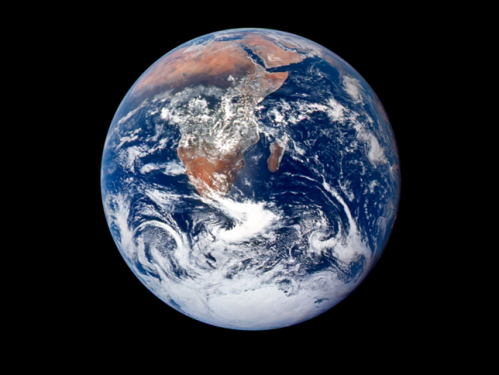 Satellite image of blue and green Earth covered with white clouds and a black background.